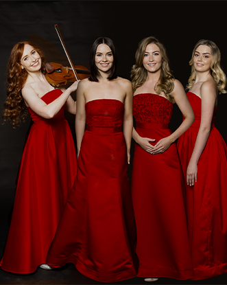 4 females in red dresses one playing violin