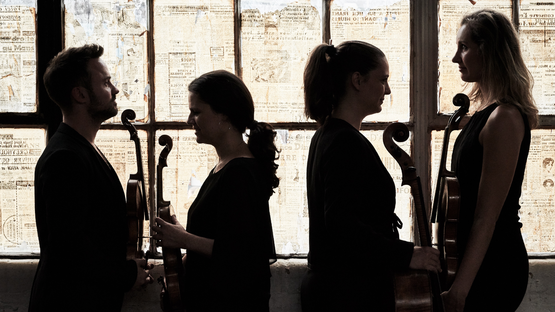 Members of the quartet in silhouettes holding their instruments 