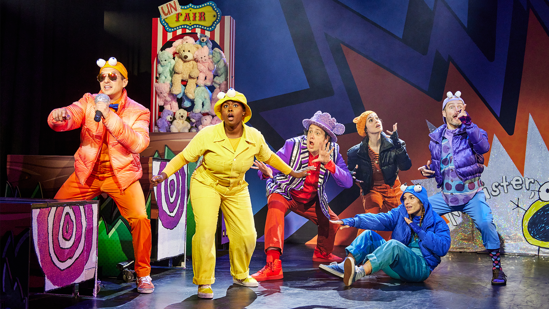 A group of characters in colorful costumes looking off into the distance 