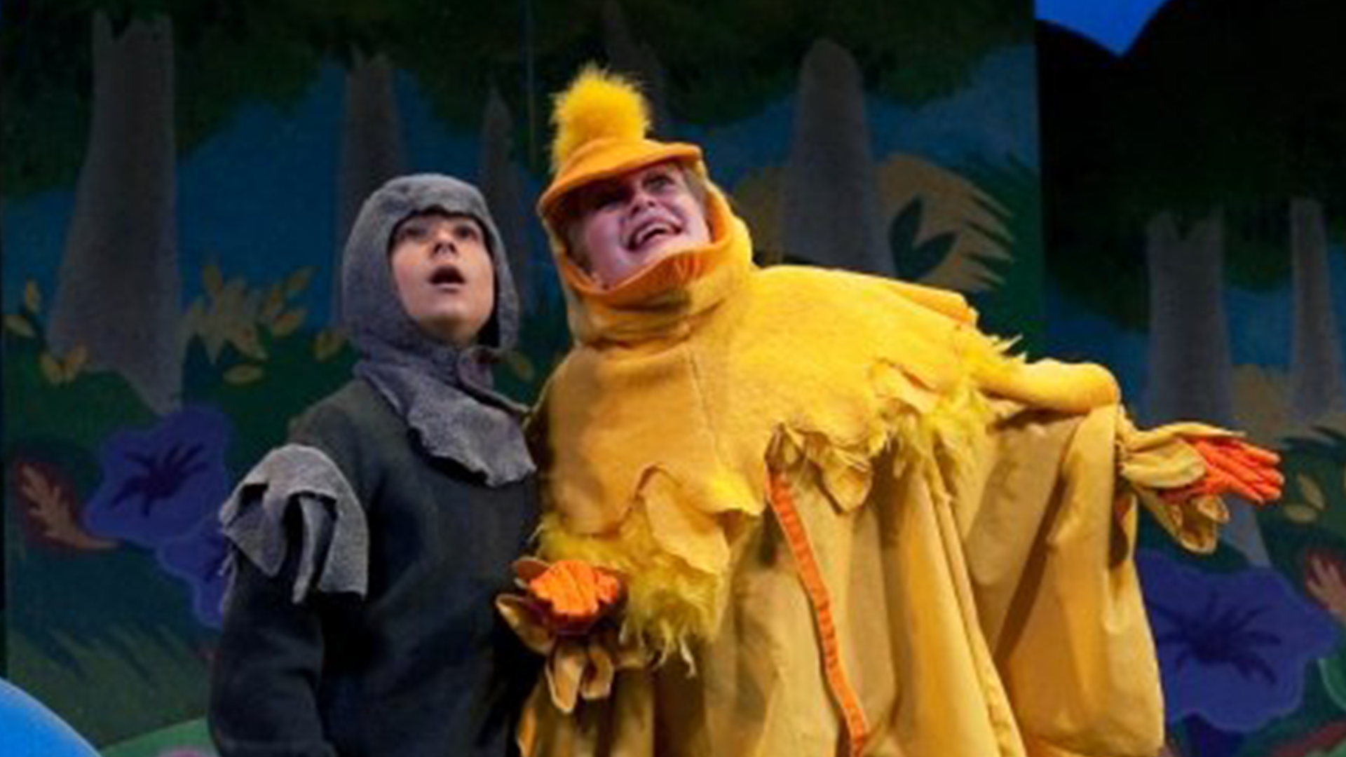 The Ugly Duckling on stage singing with another duck