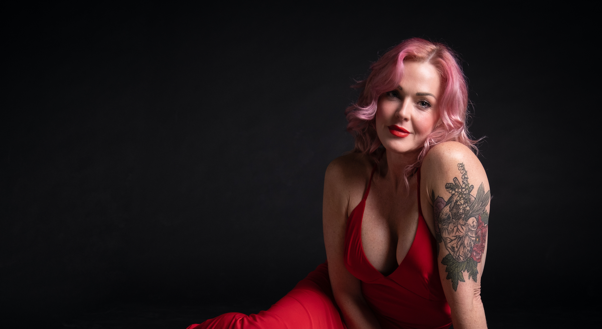 Storm Large in a red dress