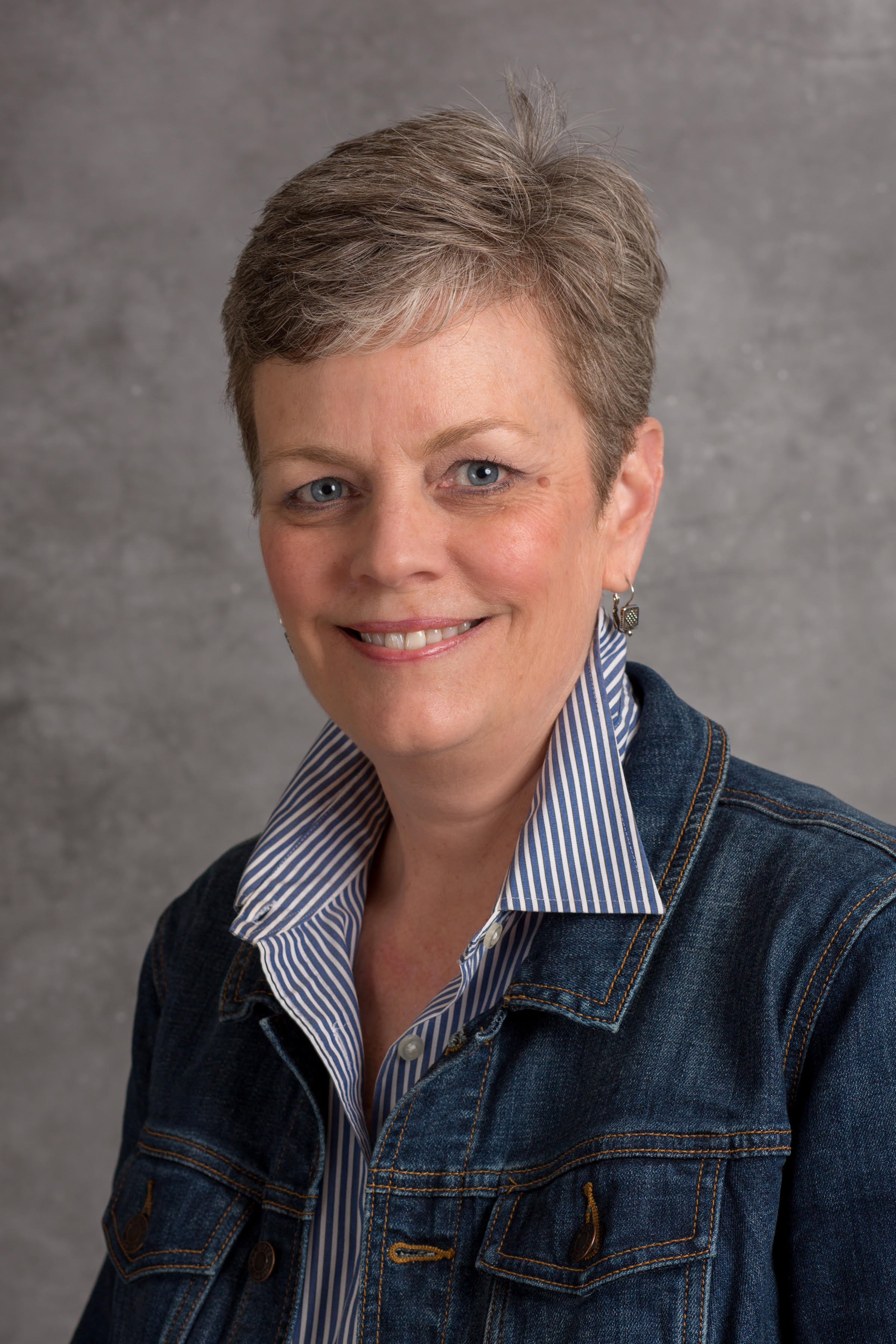 Woman in jean jacket with short hair