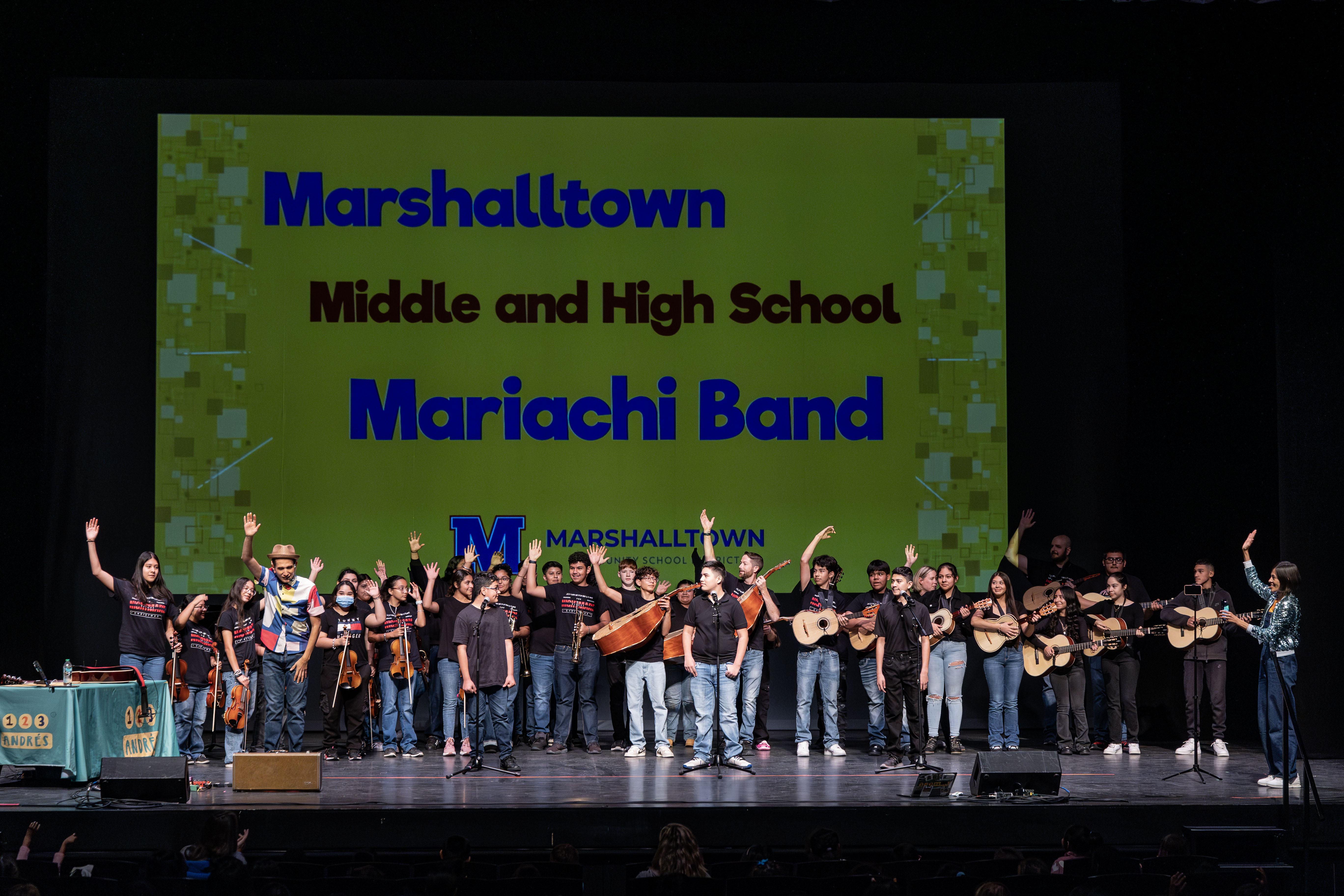 Students on stage holding instruments 123Andres