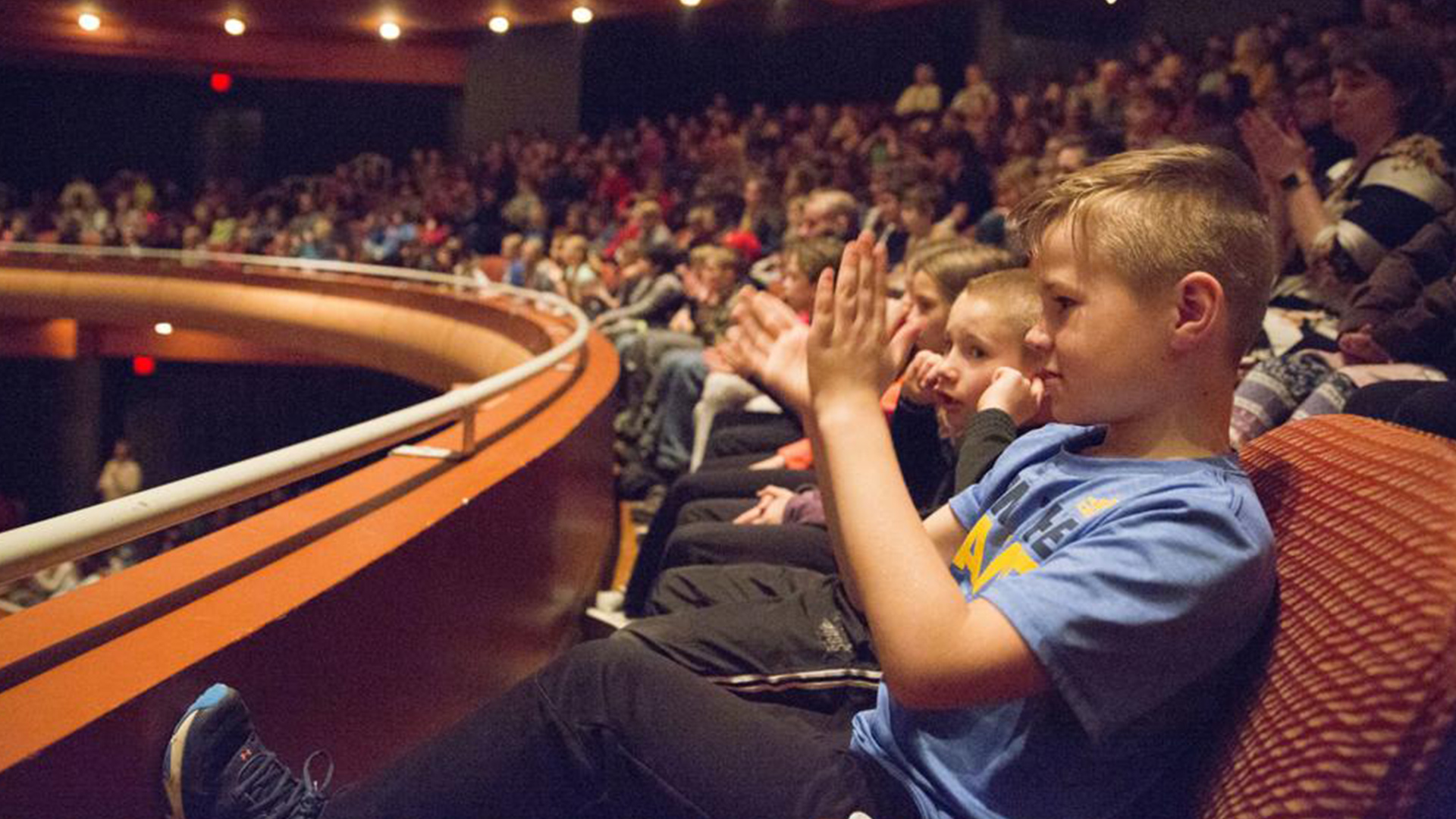 Child clapping in the Great Hall