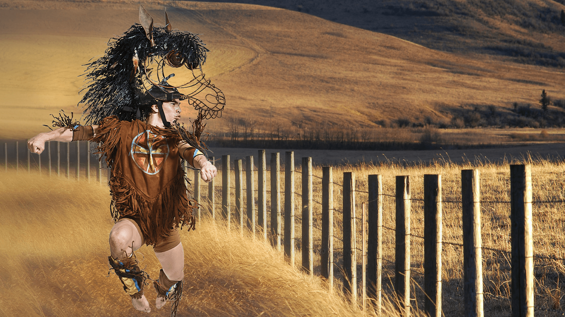 An indigenous person in a horse costume by a fence. 