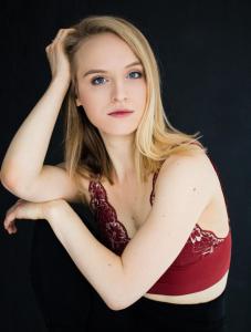 photo of young blond woman with shoulder length hair in red crop top