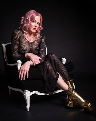 Storm Large sits in a chair