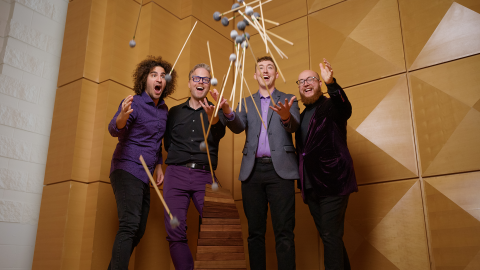 A group of guys dropping mallets towards the camera