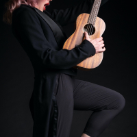 Storm Large holding a guitar